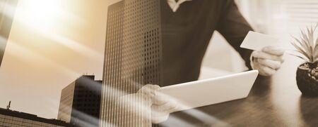 Man using digital tablet and credit card for online shopping at home; multiple exposureの写真素材