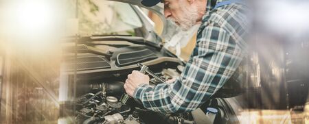 Car mechanic repairing a car engine; multiple exposure