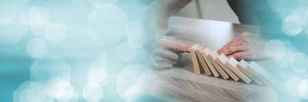 Business control concept by stopping domino effect; panoramic banner