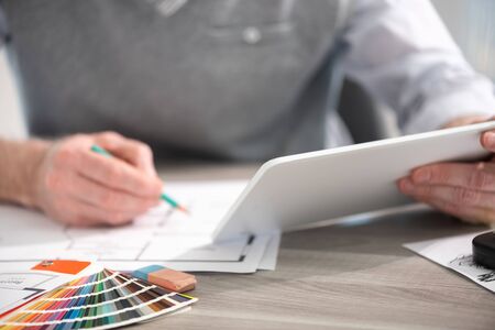 Architect working on a project and using a digital tablet
