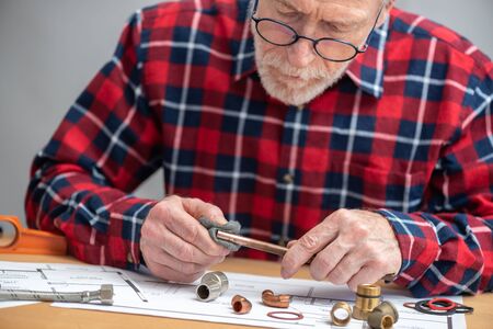 Plumber preparing a copper tube before welding