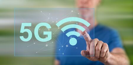 Man touching a 5g concept on a touch screen with his finger