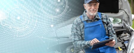 Car mechanic using digital tablet for checking car engine; panoramic bannerの写真素材
