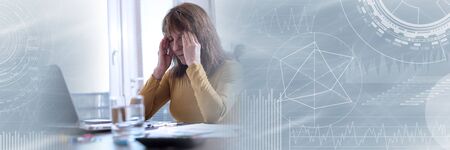 Stressed businesswoman holding hands on temples in office; panoramic banner
