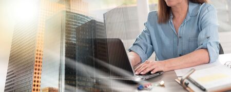 Businesswoman working on laptop in office; multiple exposure