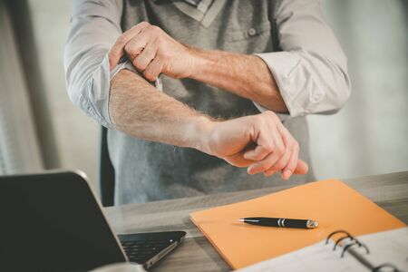 Motivated businessman rolling up his sleeves