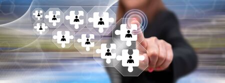 Woman touching a team concept on a touch screen with her fingerの写真素材