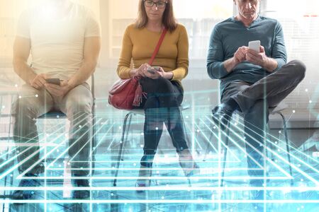 Group of people waiting for job interview and using mobile phone; multiple exposure