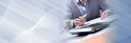 Businessman working on documents in office; panoramic bannerの写真素材
