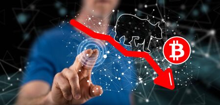 Man touching a bitcoin bearish trend concept on a touch screen with his finger
