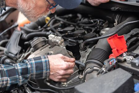 Car mechanic checking a car engineの写真素材
