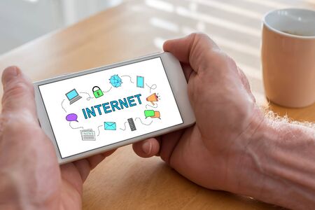 Male hands holding a smartphone with internet conceptの写真素材