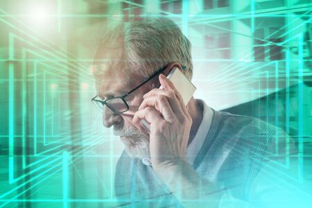 Bearded senior businessman talking on mobile phone in office, hard light; multiple exposure