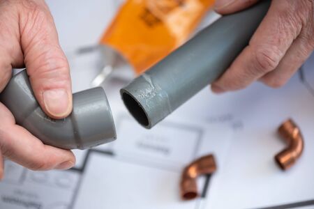 Plumber joining pvc pipe and fittingの写真素材