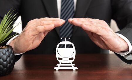 Insurer protecting a train with his handsの写真素材