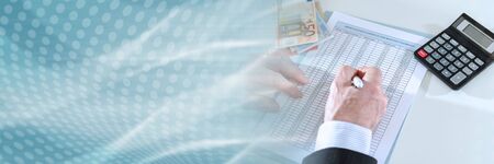 Businessman making investment calculations; panoramic banner