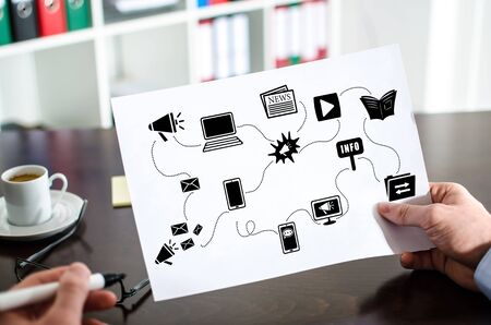 Hand holding a paper showing communication media conceptの写真素材