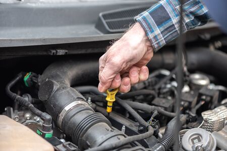 Car mechanic checking a car engine