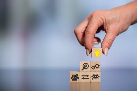 Concept of brainstorming with icons on wooden cubes