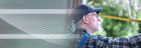 Senior repairman taking measures with tape measure; panoramic banner