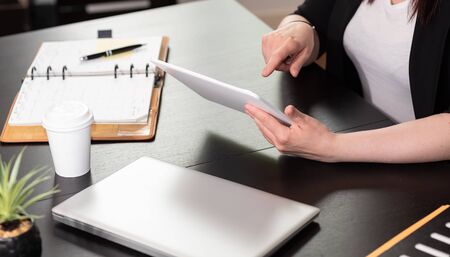 Businesswoman using digital tablet at workplace