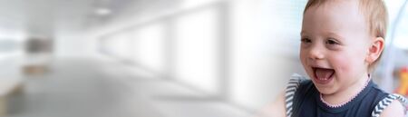 Portrait of happy cute baby girl with a beautiful smile; panoramic bannerの写真素材