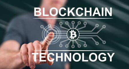 Man touching a blockchain technology concept on a touch screen with his finger