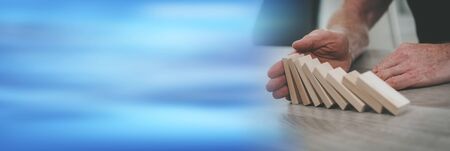 Business control concept by stopping domino effect; panoramic banner