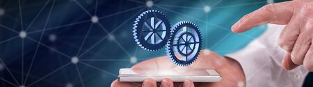 Teamwork concept above a smartphone held by a manの写真素材
