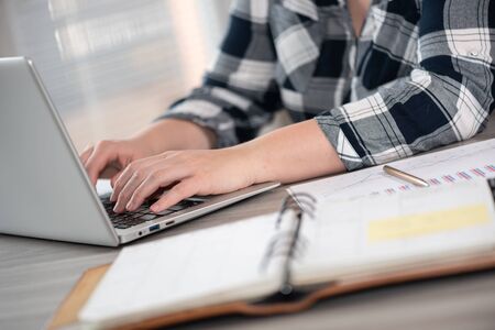 Female hands typing on laptop keyboard