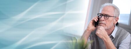 Portrait of senior businessman talking on mobile phone; panoramic banner