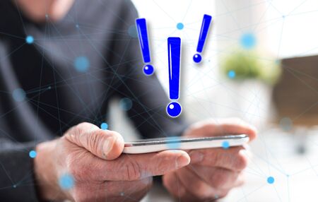 Hands of man holding a smartphone with caution concept