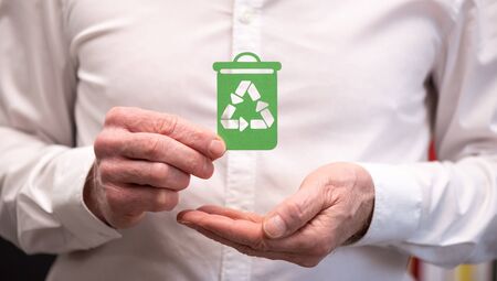 Man holding a recycling bin; Concept of recyclingの写真素材