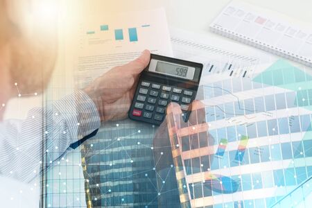Businessman checking financial graphs, at the office; multiple exposureの写真素材