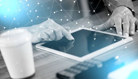 Businesswoman using digital tablet at workplace; light effect