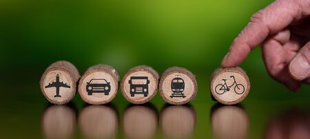 Concept of eco travel with icons on wooden logsの写真素材