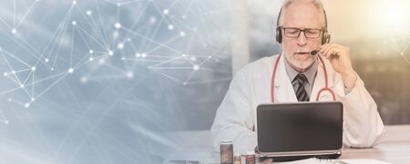 Portrait of senior doctor during online medical consultation; panoramic banner