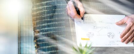Businessman working on marketing strategy improvement at office; multiple exposureの写真素材