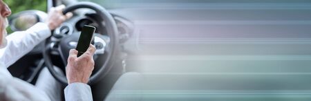 Man using his mobile phone while driving; panoramic banner