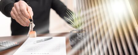 Real estate agent showing house keys after contract signing; multiple exposure