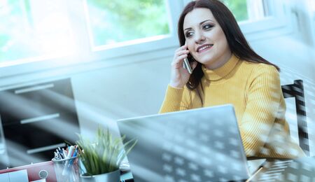 Portrait of young businesswoman working from home; light effect