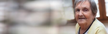 Portrait of a smiling elderly woman; panoramic bannerの写真素材