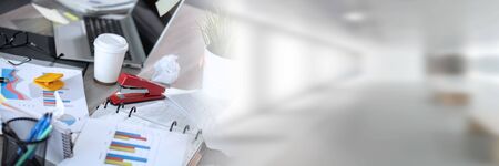 Messy and cluttered office desk; panoramic banner