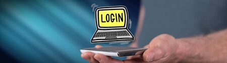 Login concept above a smartphone held by a manの写真素材