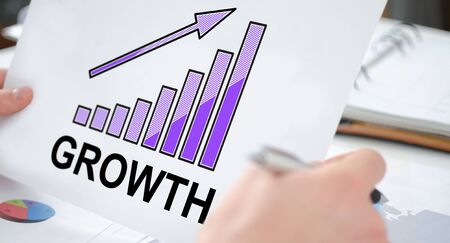 Hands holding a paper showing a growth conceptの写真素材