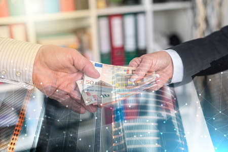 Hands exchanging cash; multiple exposureの写真素材