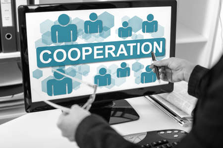 Businesswoman showing cooperation concept on a computer screenの写真素材