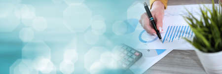 Businesswoman analysing marketing data; panoramic banner