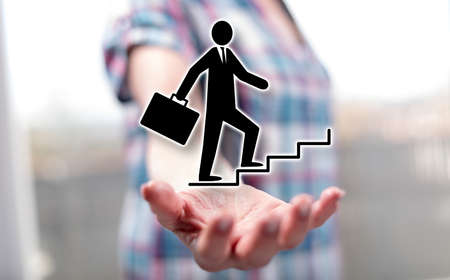 Ambition concept above the hand of a woman in background
