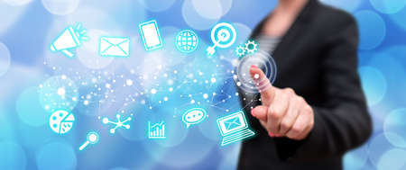 Woman touching a digital marketing concept on a touch screen with her finger